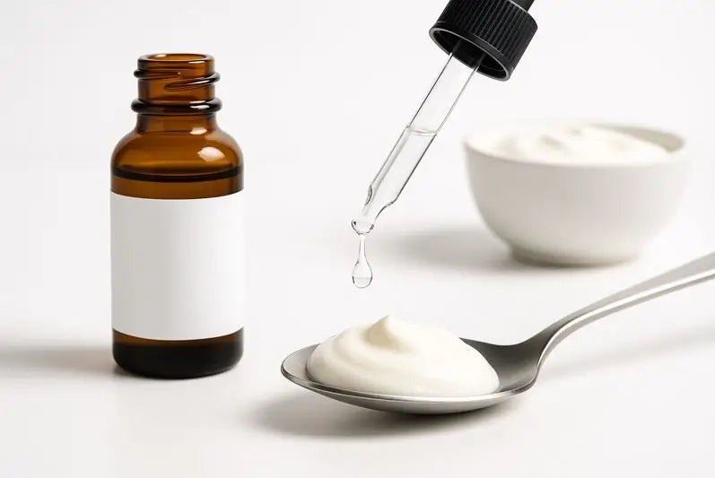 Clear vitamin D drop over yoghurt on a spoon