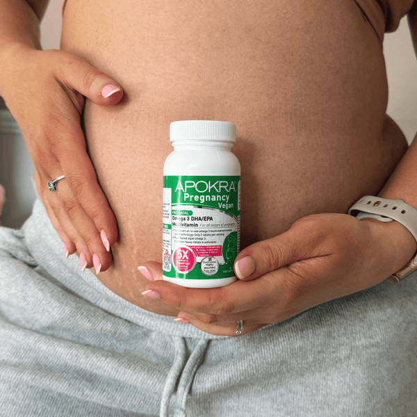 Pregnant mum holding the APOKRA Pregnancy bottle