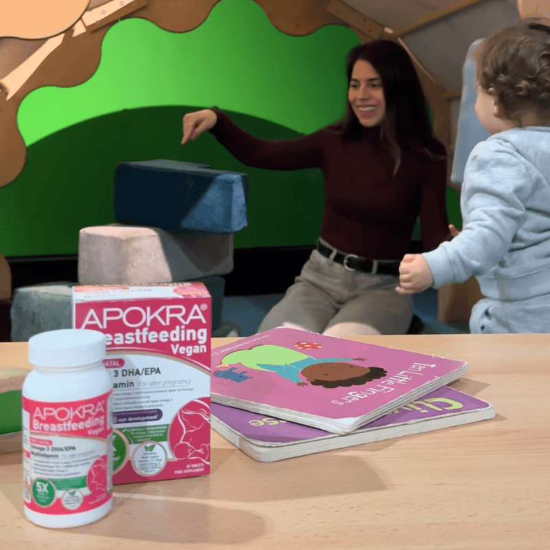 Mum and toddler playing at home with APOKRA Breastfeeding vitamins on the table